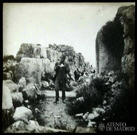 Tirinto (Grecia). Galería y resto de puerta, con hombre leyendo entre las ruinas
